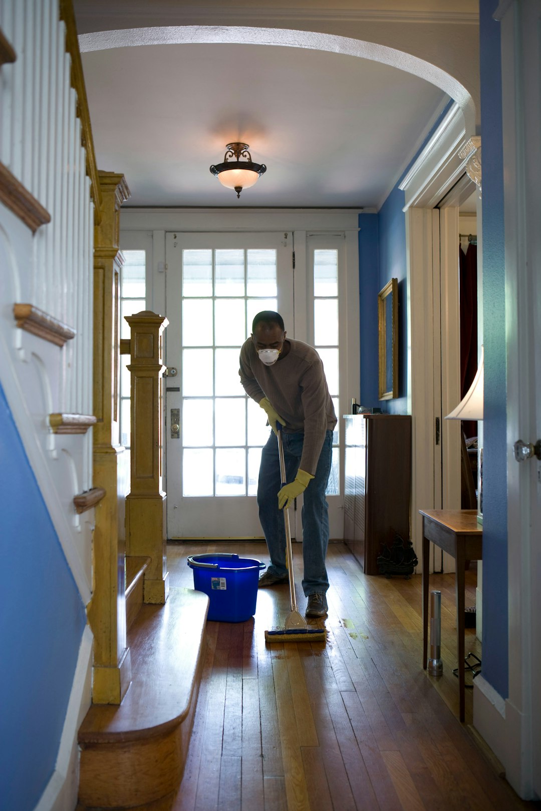 about-01 This African-American man was in the process of damp-mopping his home’s entrance way. In this way airborne particulates including dust and pollen, could be removed from the inside of his home, thereby, reducing the detrimental effects these substances have upon the respiratory system of his family members. These irritants can sometimes result in sinus infections, and asthma.
