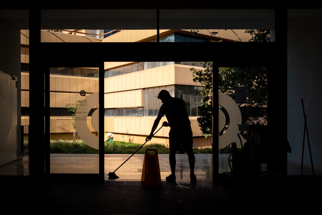 services-02 Man cleans floor at an entrance door.